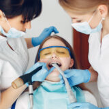 Same-day emergency dentist in Charlotte NC examining a patient with tooth pain